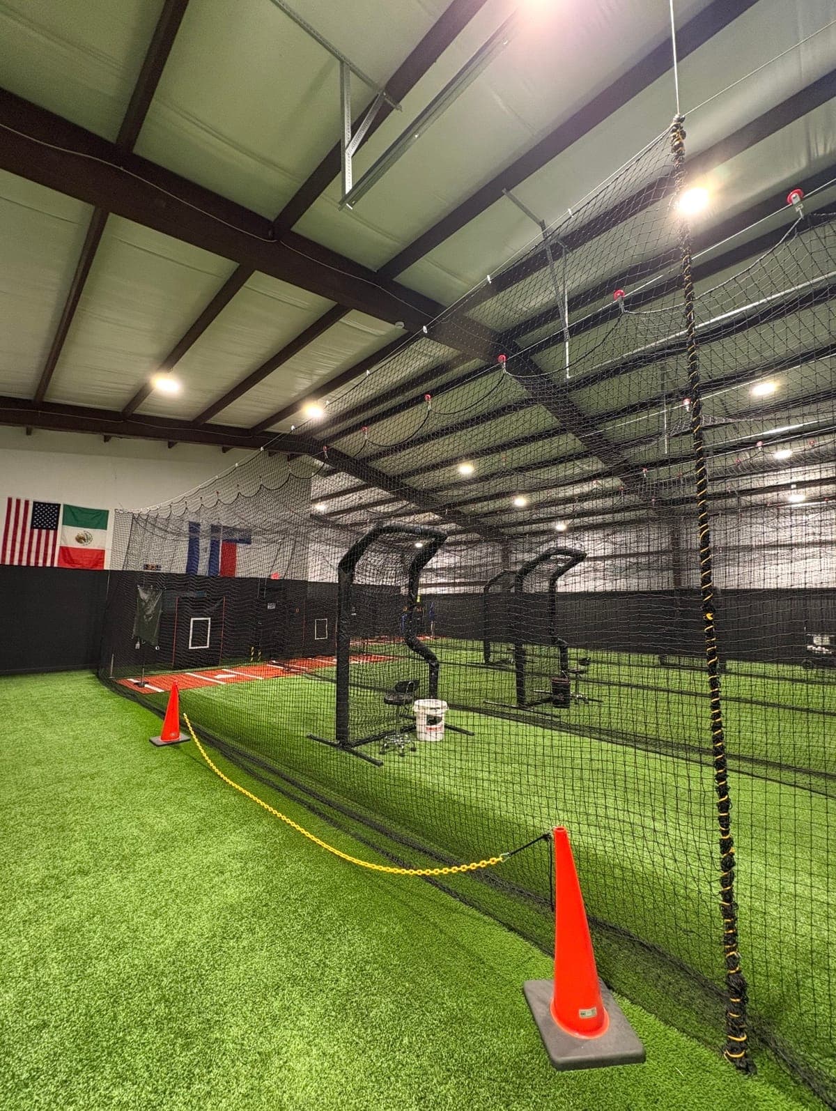 Indoor batting cages on turf at a training facility used for Baseline workouts